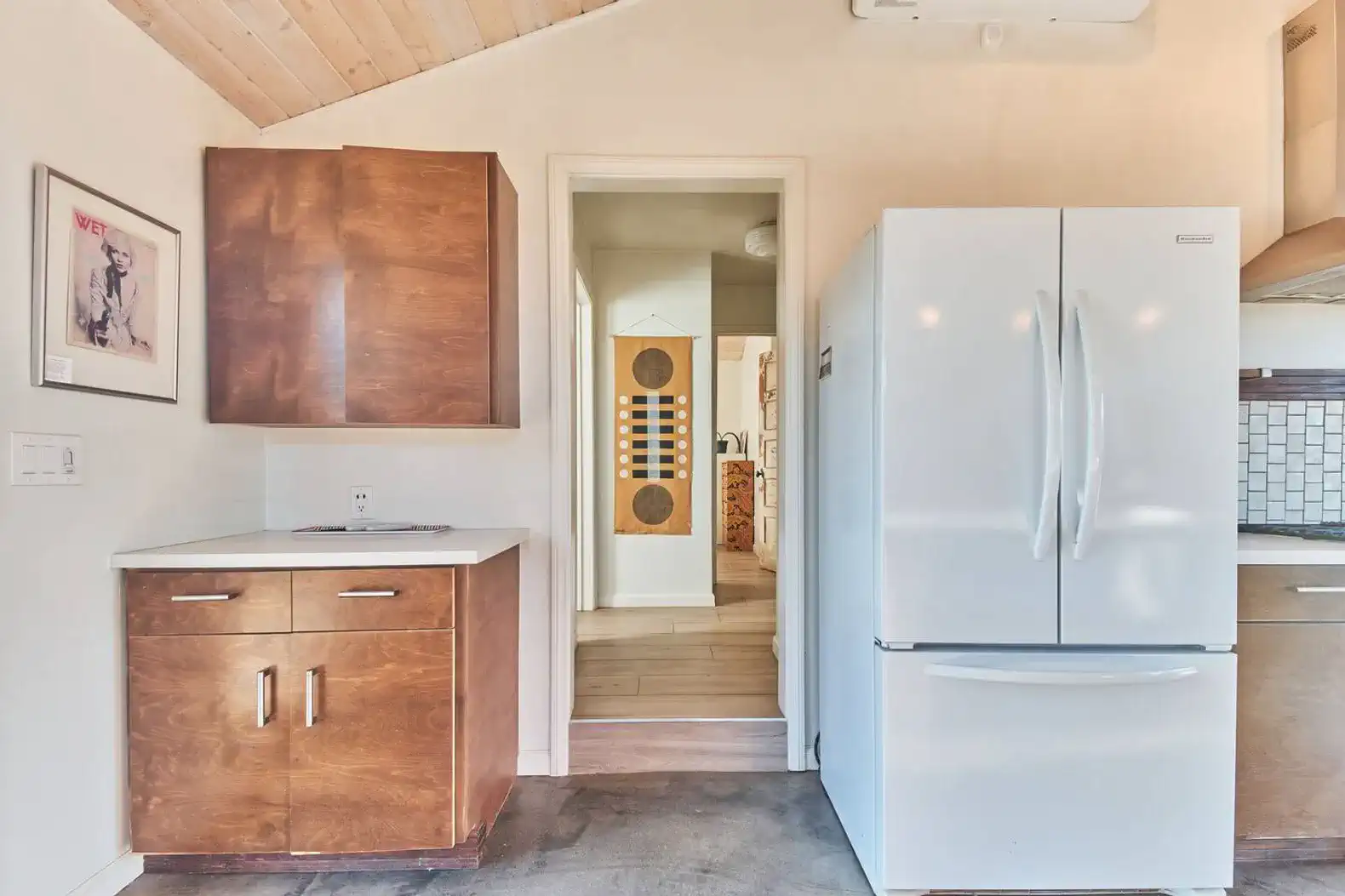 Modern kitchen with wooden cabinets and a large refrigerator