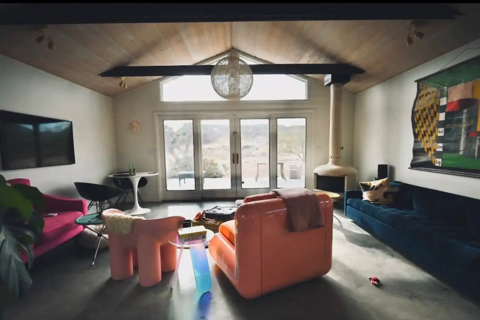 Stylish living room featuring colorful furniture and large windows with mountain views