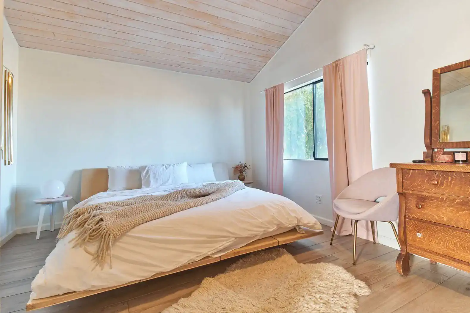 Cozy master bedroom with a large bed, soft linens, and natural light from a window
