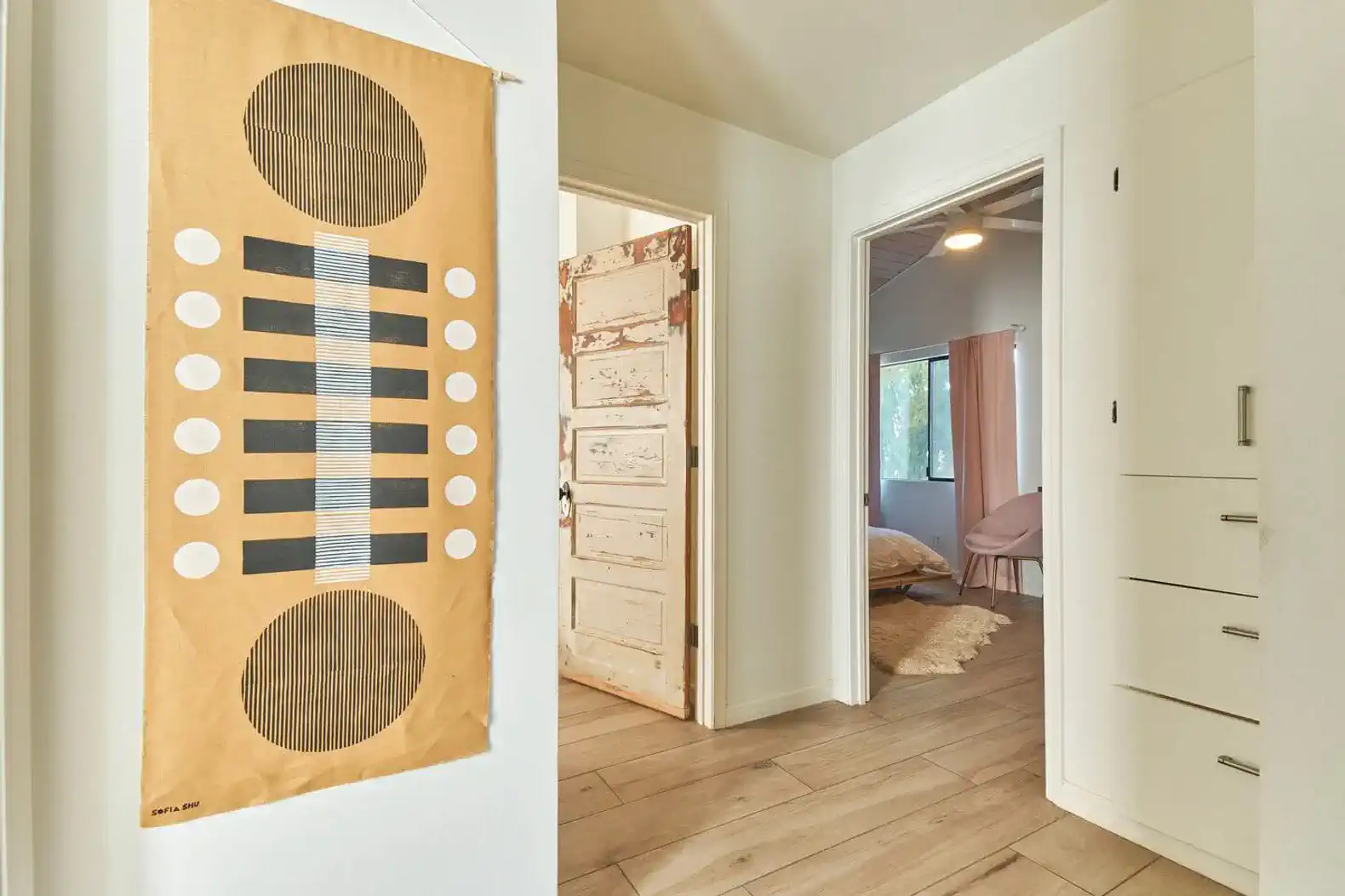 Stylish hallway with decorative wall art and doors leading to bedrooms