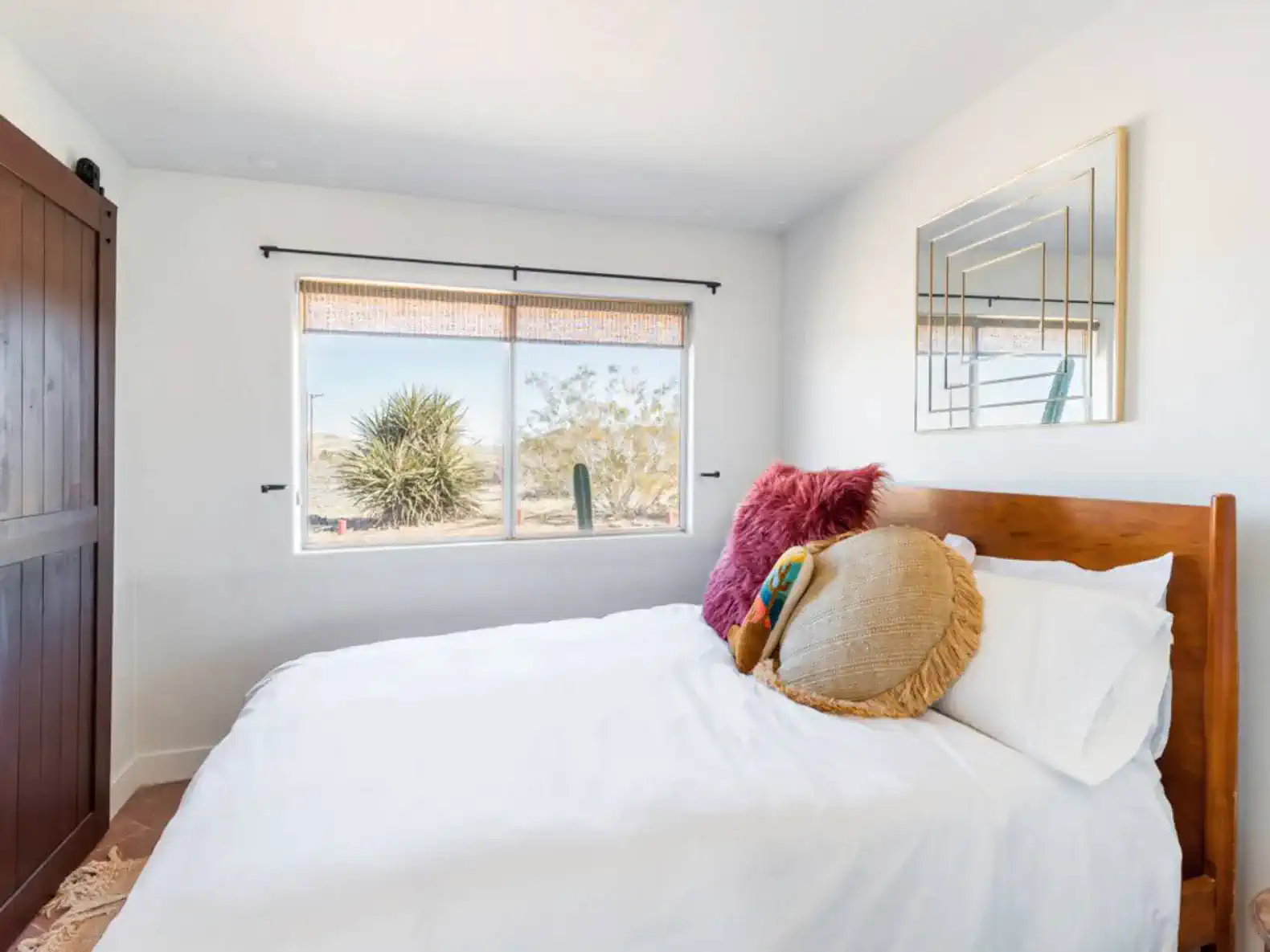 Cozy guest bedroom with a queen bed and decorative pillows
