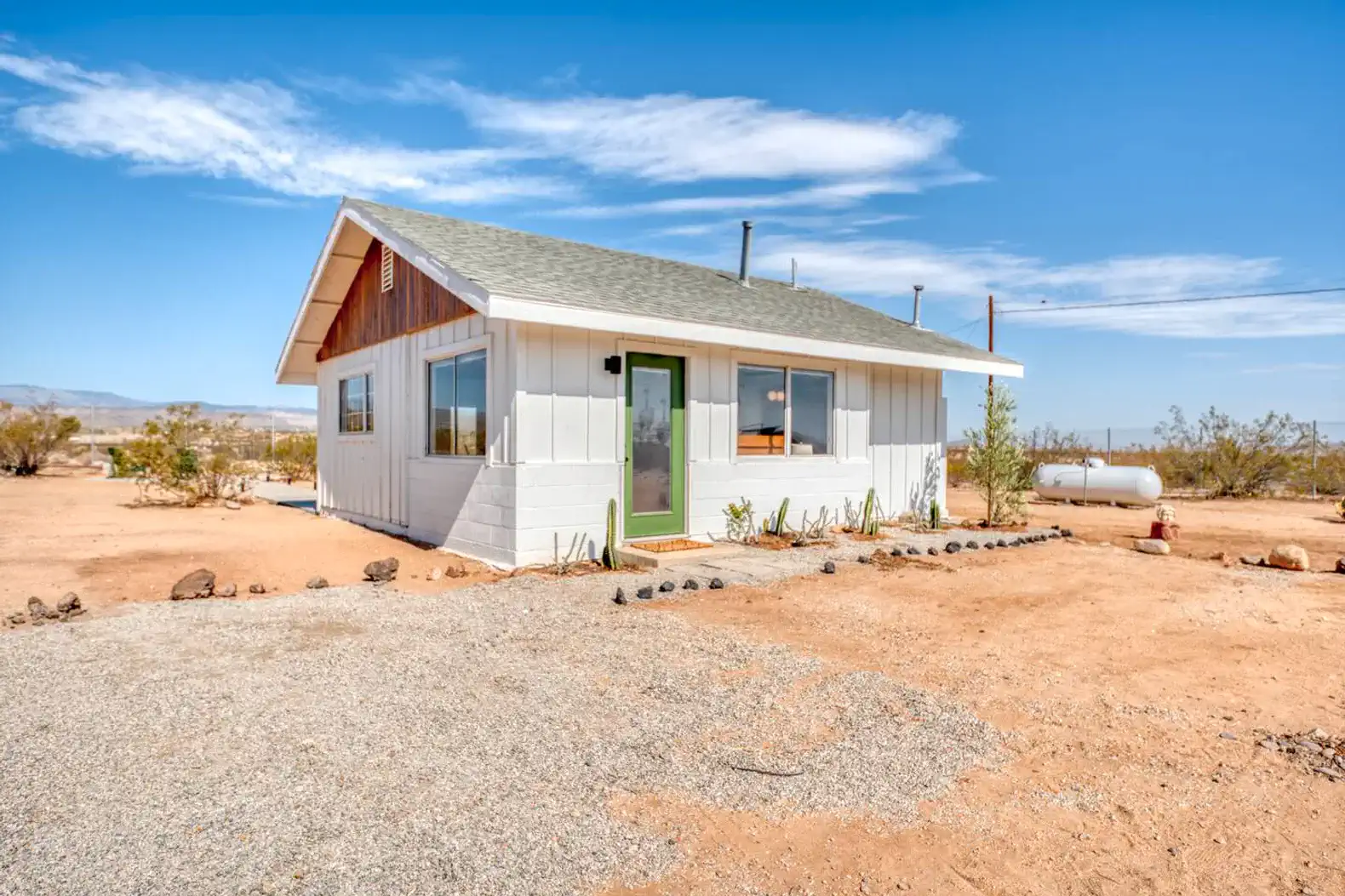 Charming desert house with large windows and gravel driveway