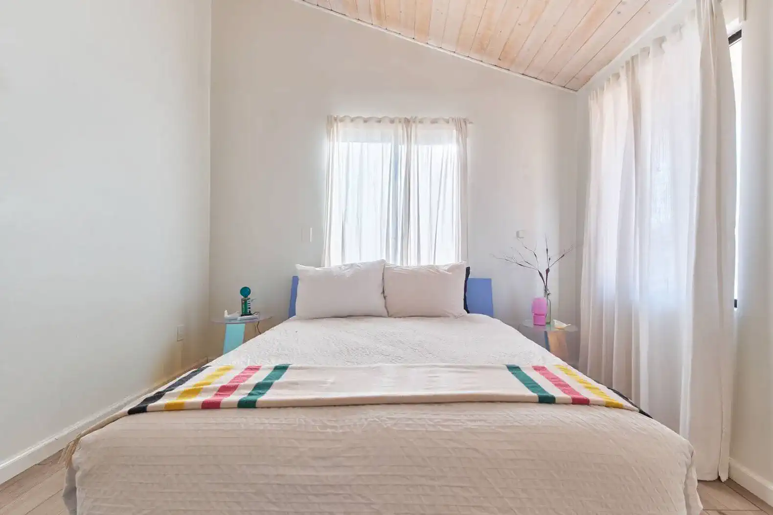 Cozy guest bedroom with natural light and simple decor