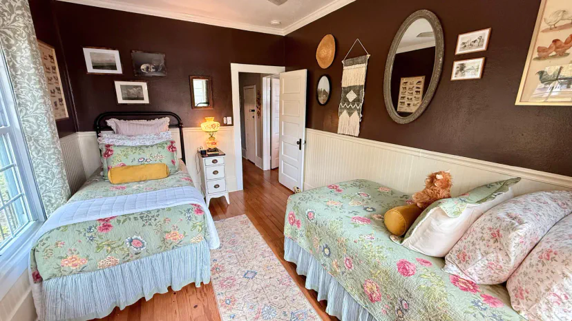 The other main floor bedroom has two cozy twin beds and a nightstand and reading lamp for each one. And guess what? The curtains are not just any curtains - they’re blackout curtains! You can pull them closed to create a super dark and cozy space.