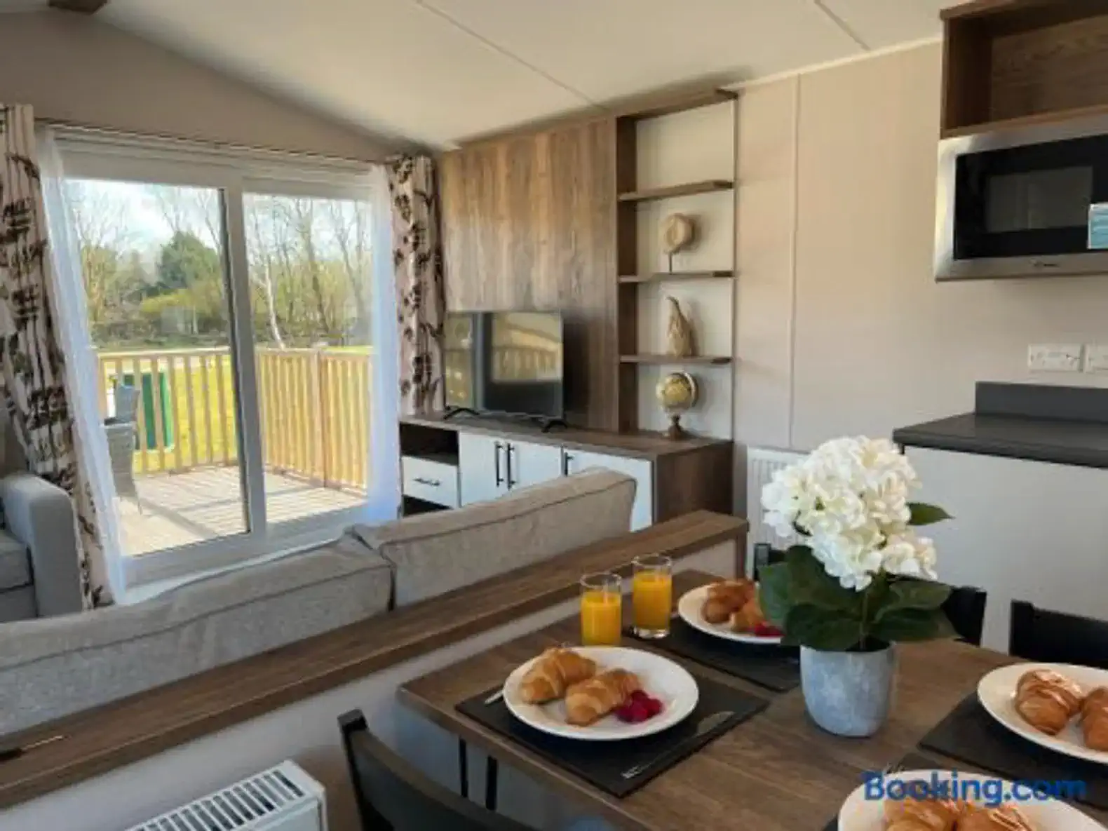 Cozy living area with breakfast setup and sliding doors to the deck