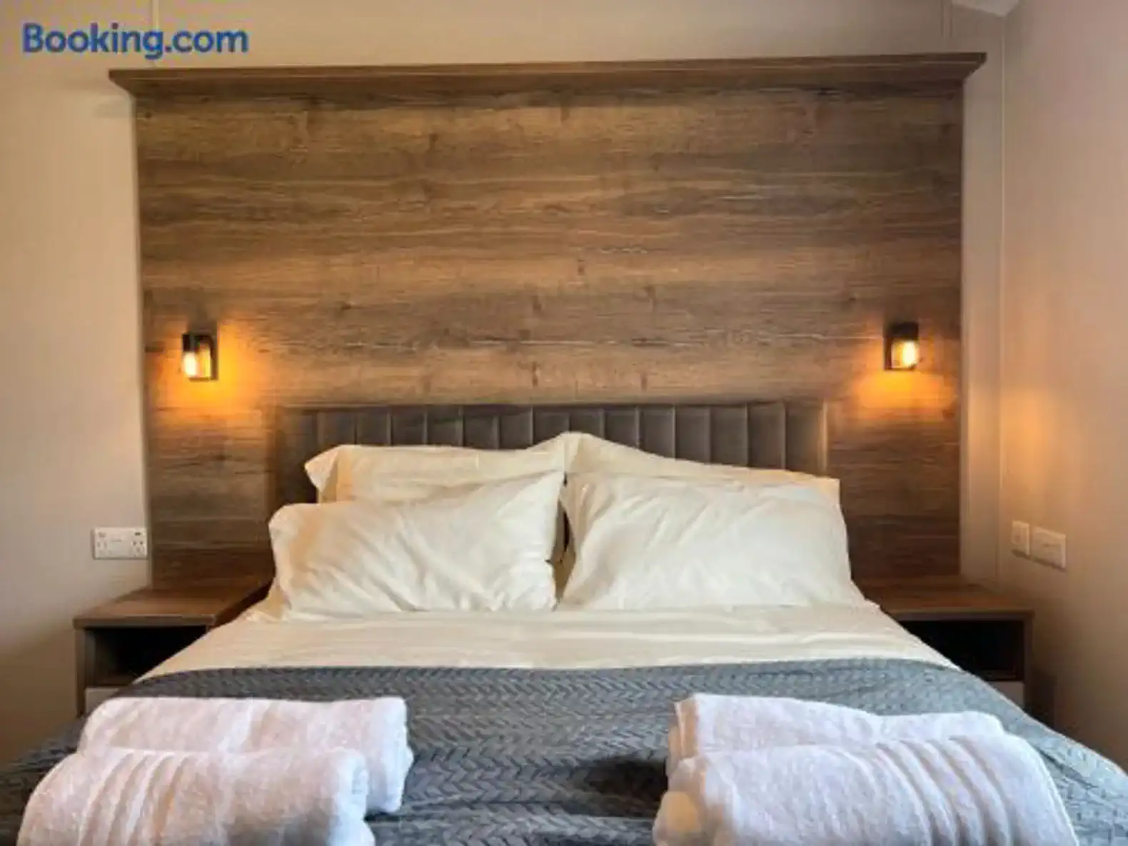 Cozy master bedroom with wooden headboard and soft bedding
