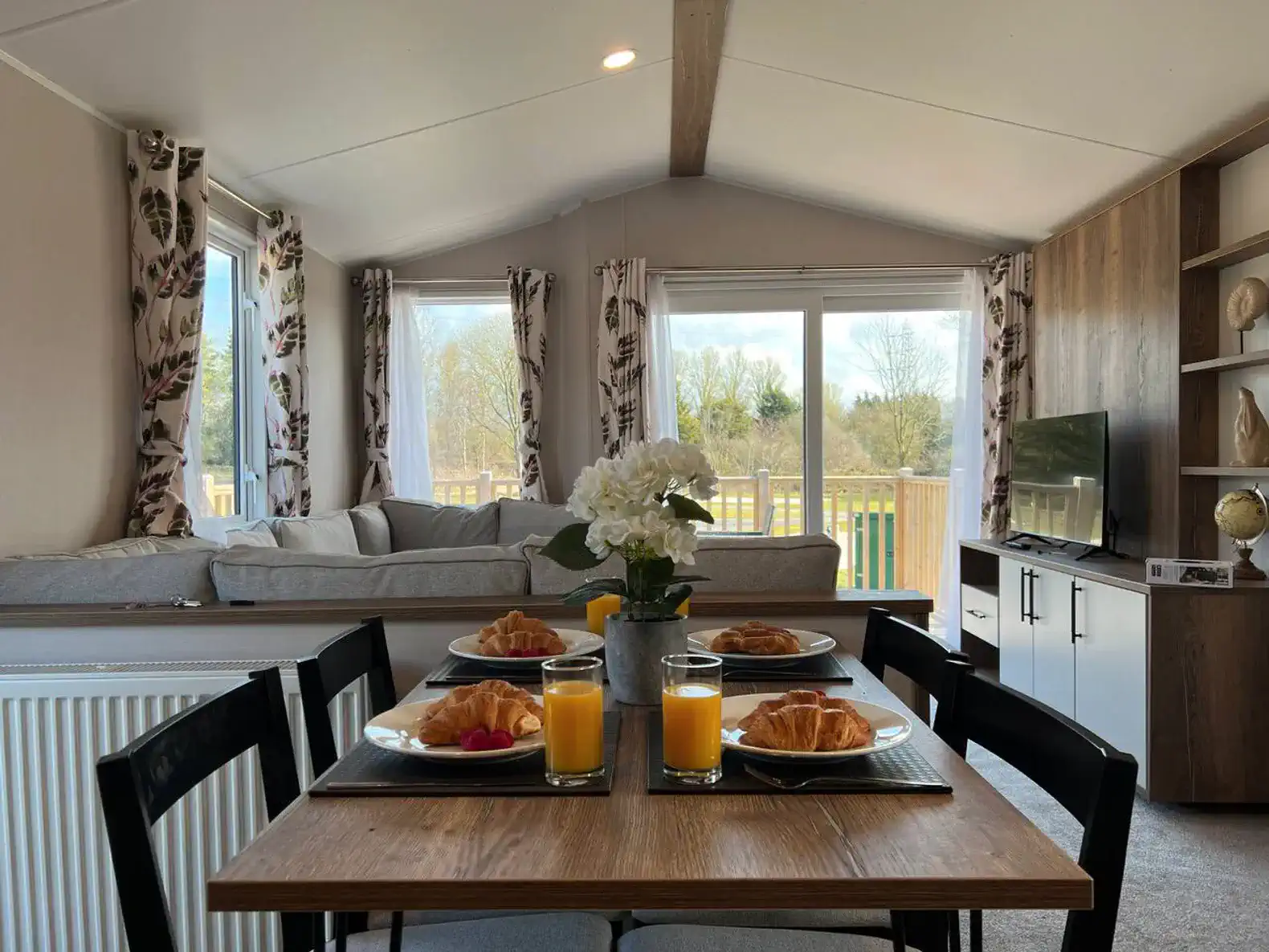 Cozy dining area with breakfast setup and views of the living room
