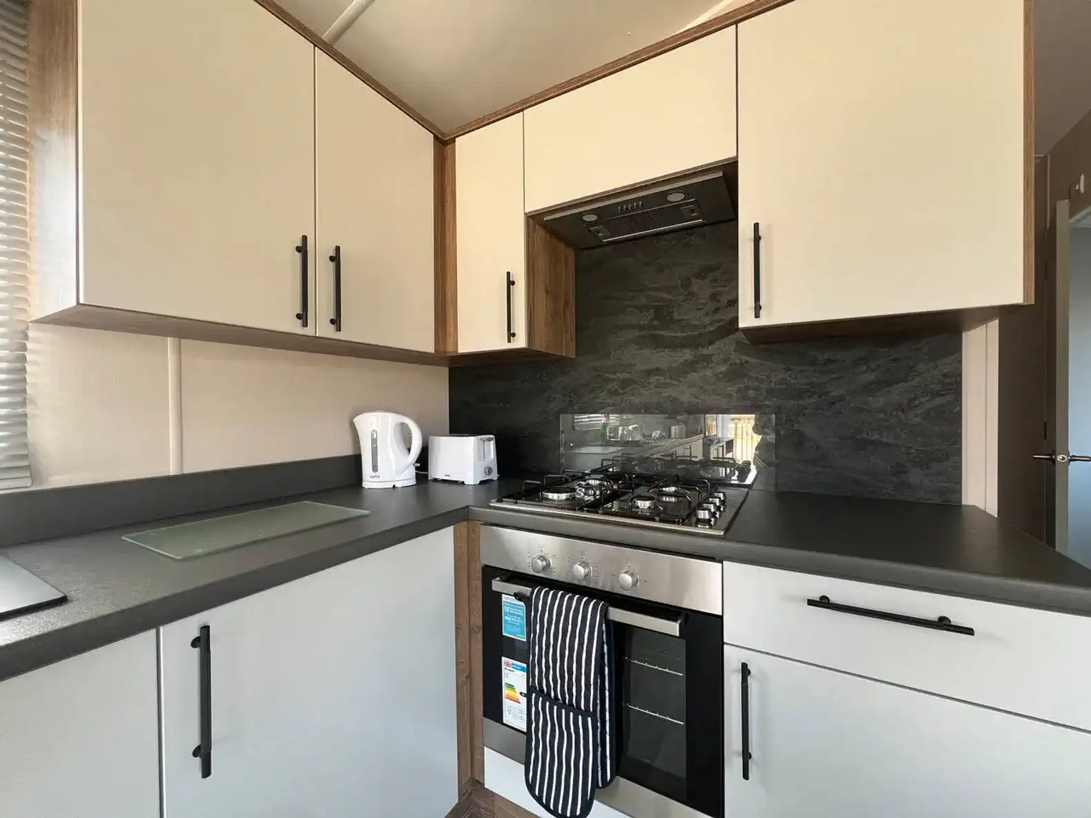 Modern kitchen with sleek cabinets, gas stove, and countertop appliances