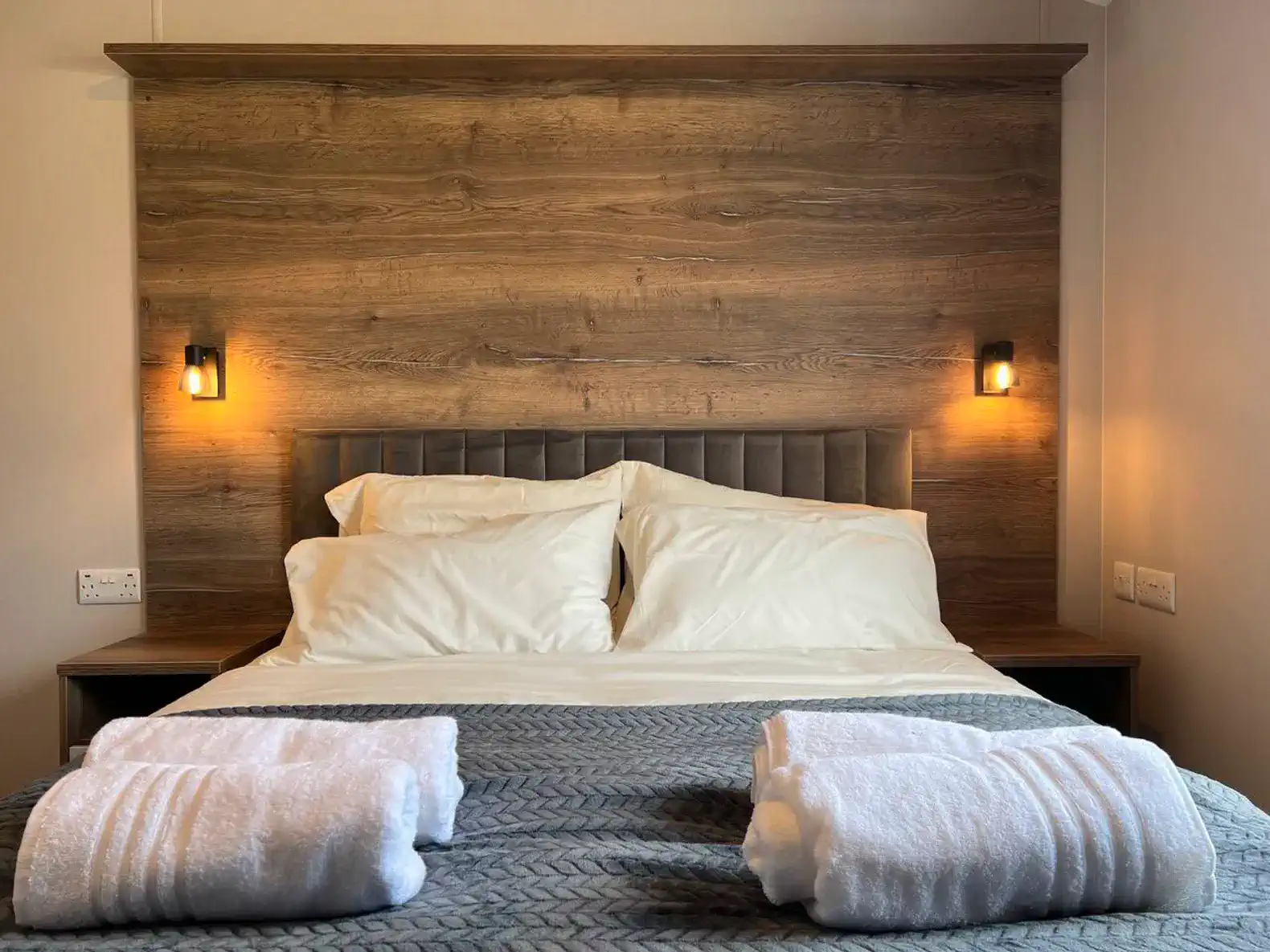 Cozy master bedroom with a wooden headboard and soft lighting