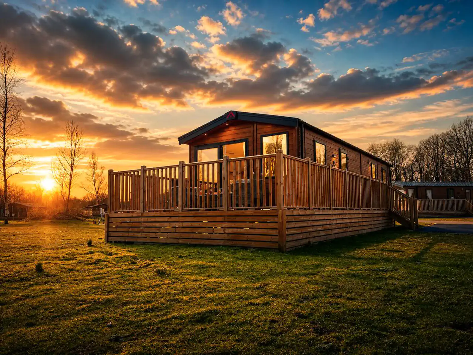 Wooden cabin with a spacious deck at sunset