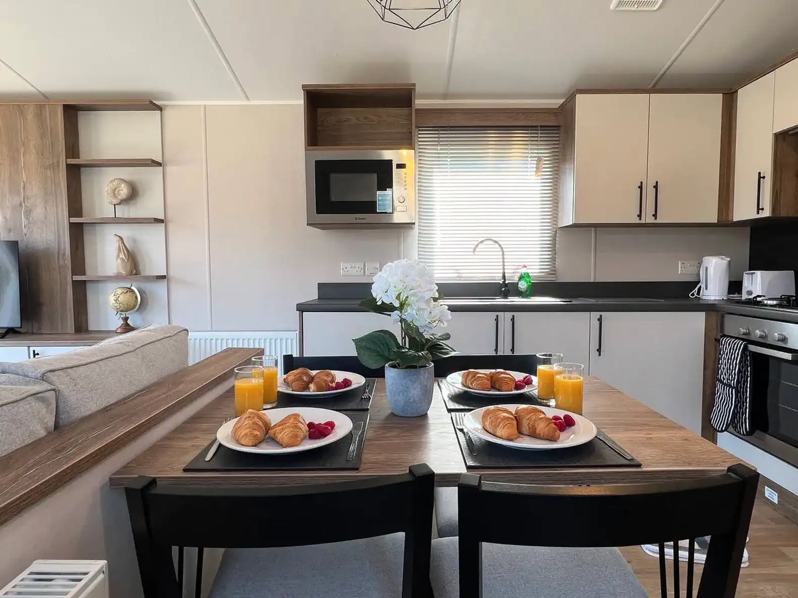 Cozy dining area with breakfast spread, including croissants and drinks