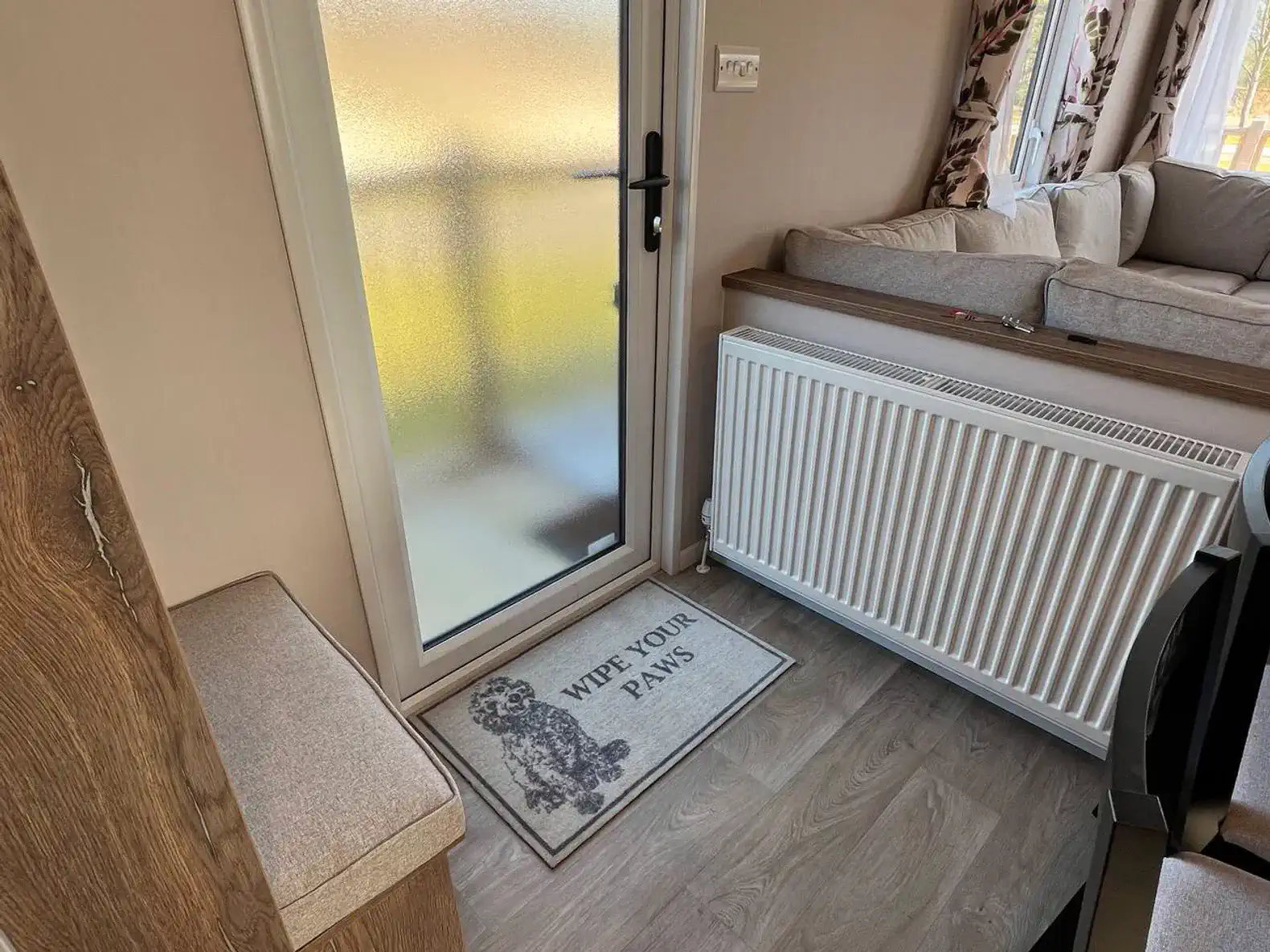 Entrance area with a welcome mat and a frosted glass door