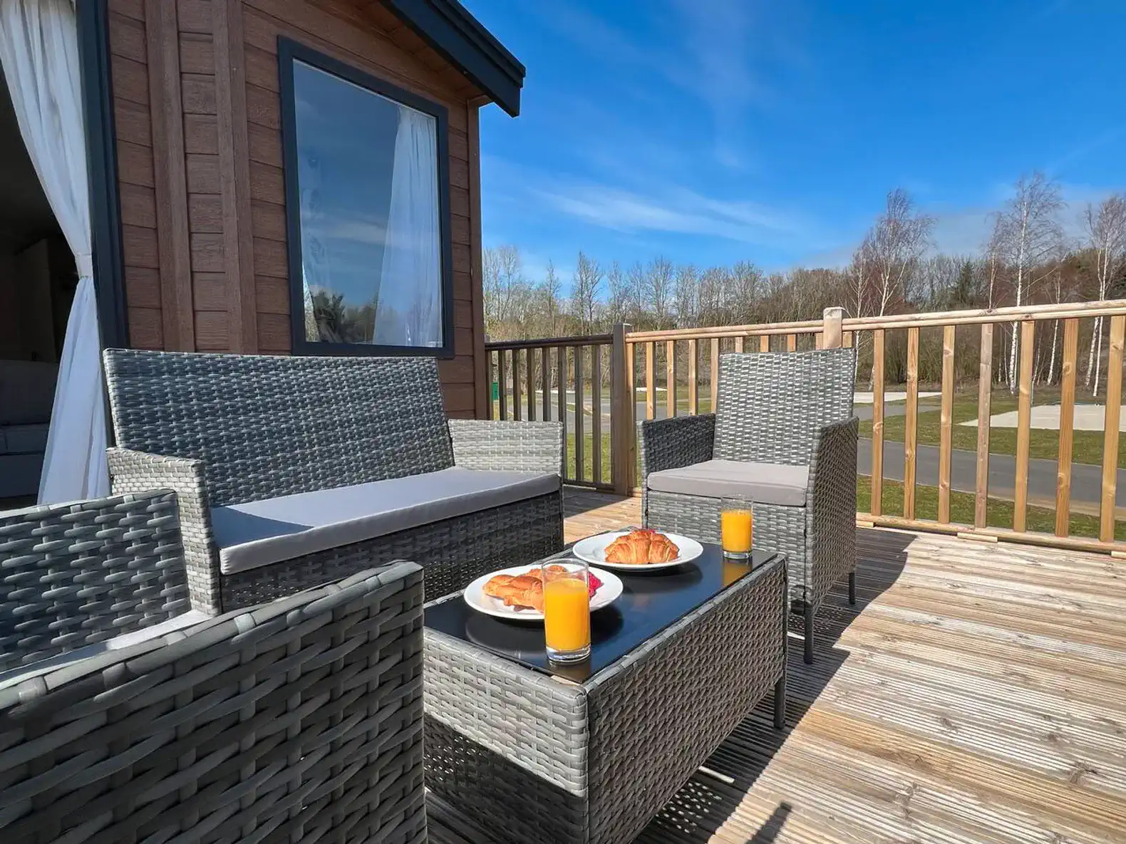 Outdoor seating area with breakfast on a sunny deck