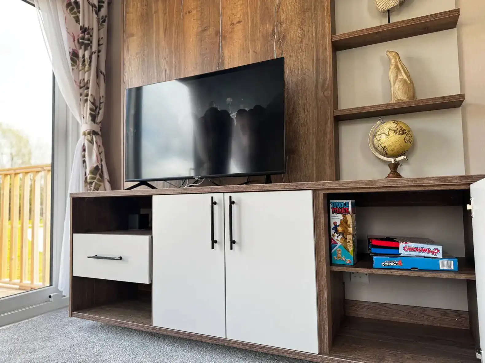 Modern entertainment unit with TV and games in a cozy living area