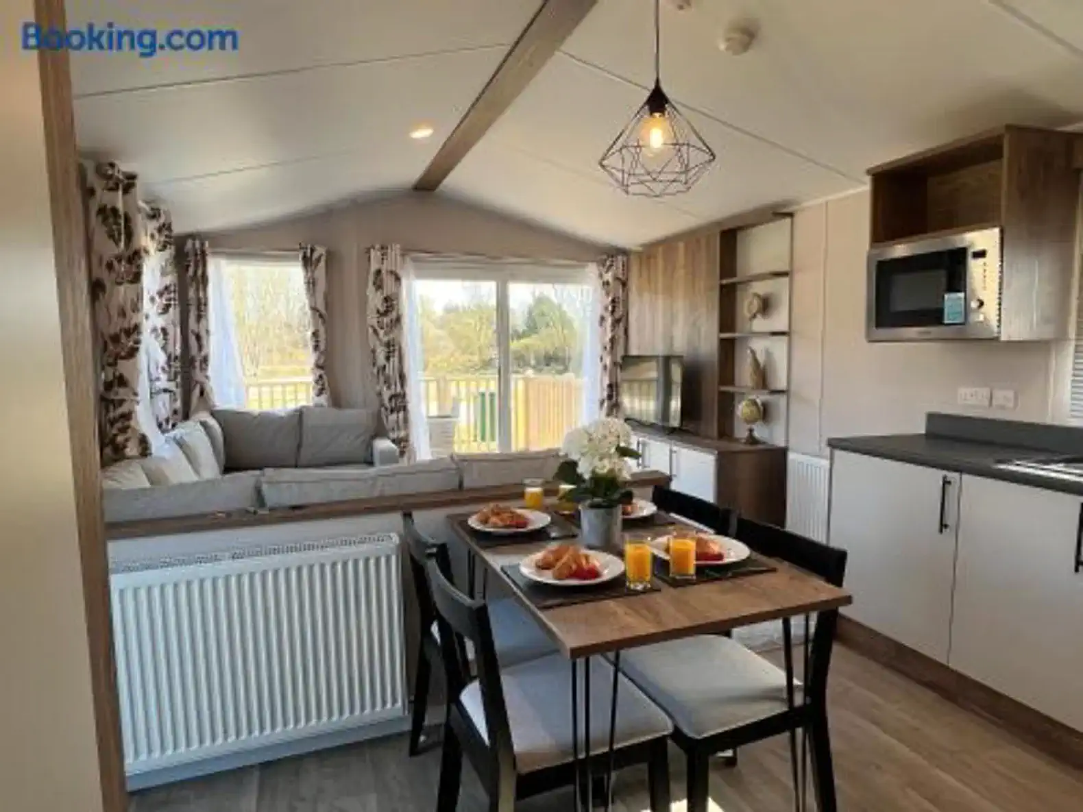 Cozy dining area with a view, featuring a table set for breakfast and a living space in the background