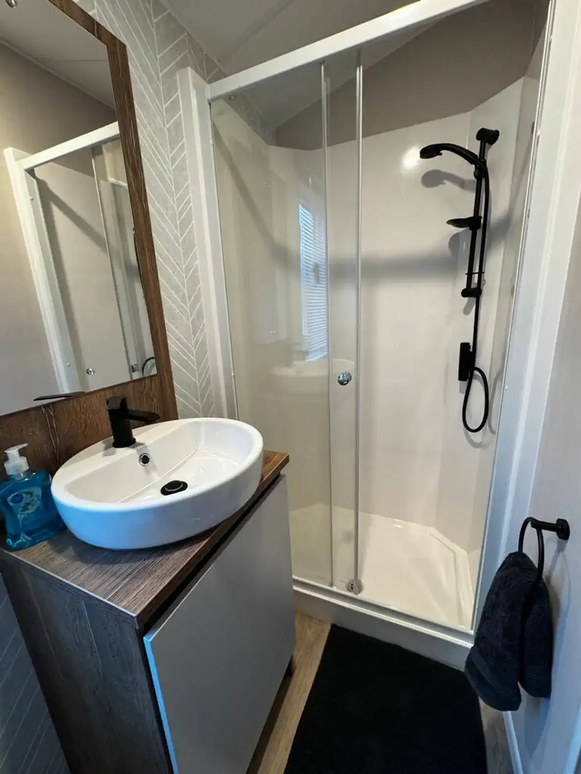 Modern bathroom featuring a glass shower and stylish sink