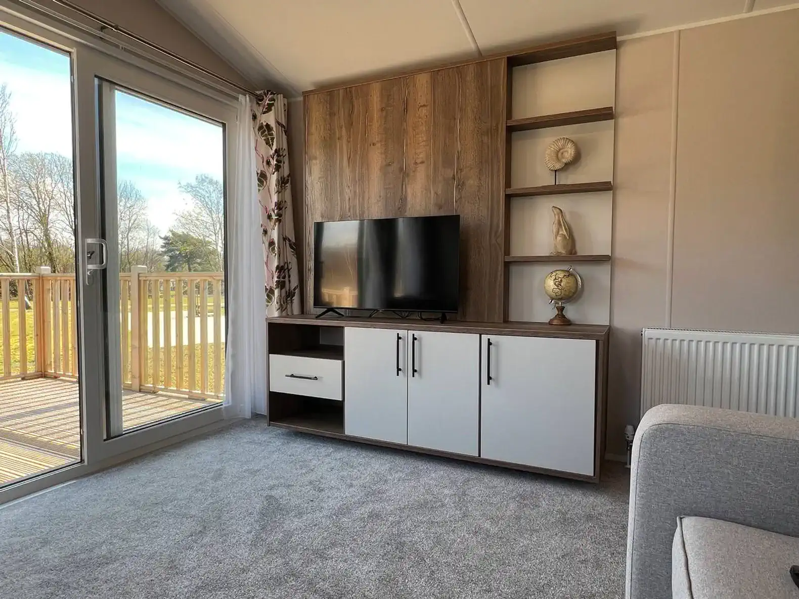 Cozy living area with a TV unit and sliding glass doors to a deck