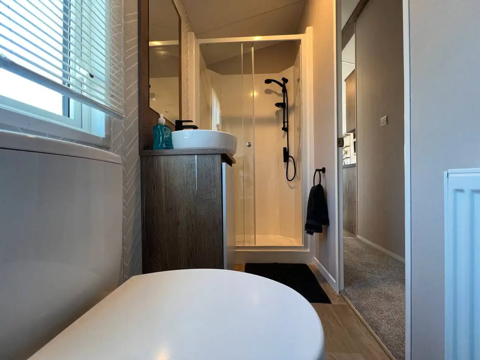 Modern bathroom featuring a shower, sink, and toilet with stylish decor