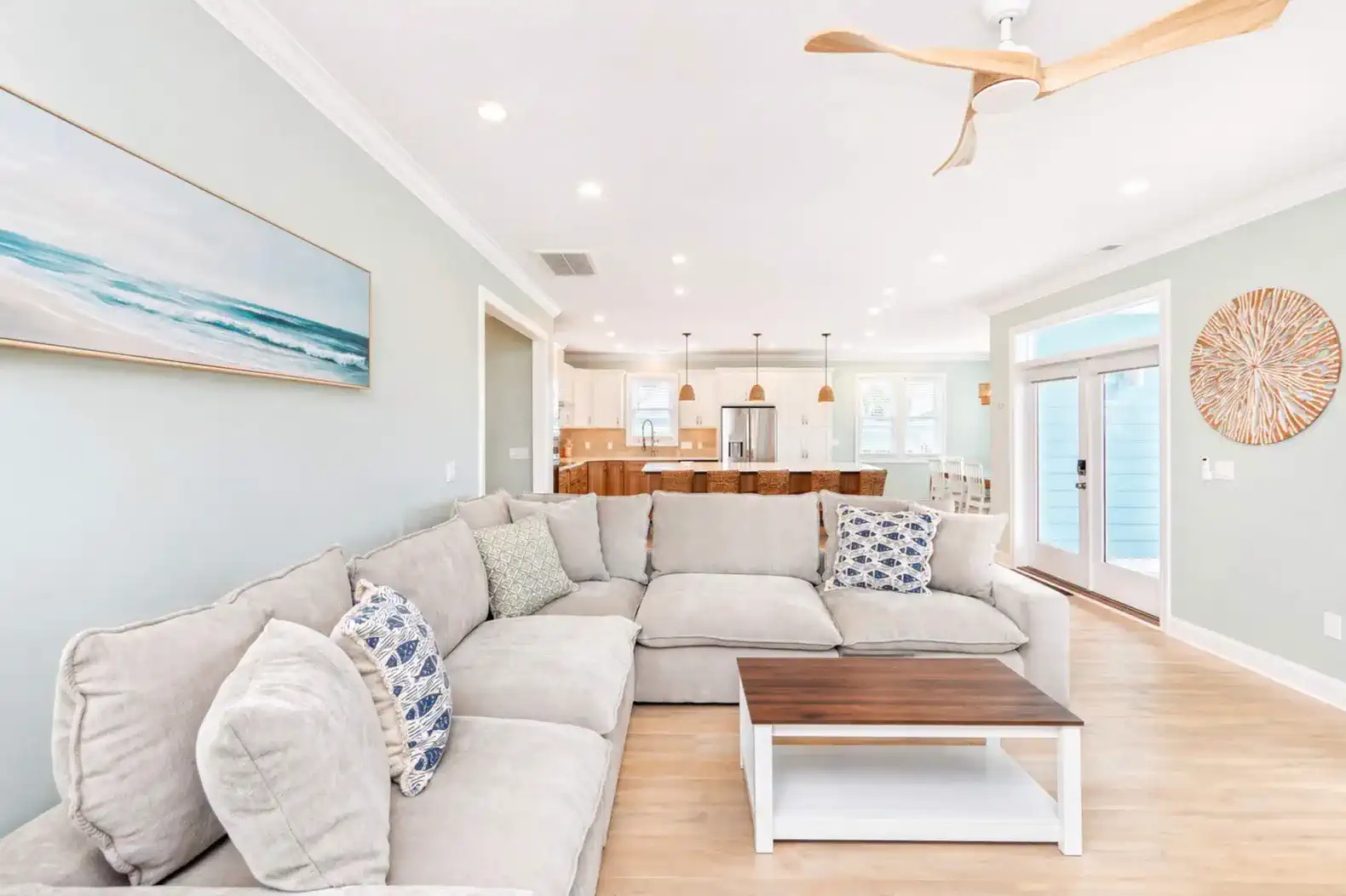 Spacious living room with sectional sofa and open layout to kitchen