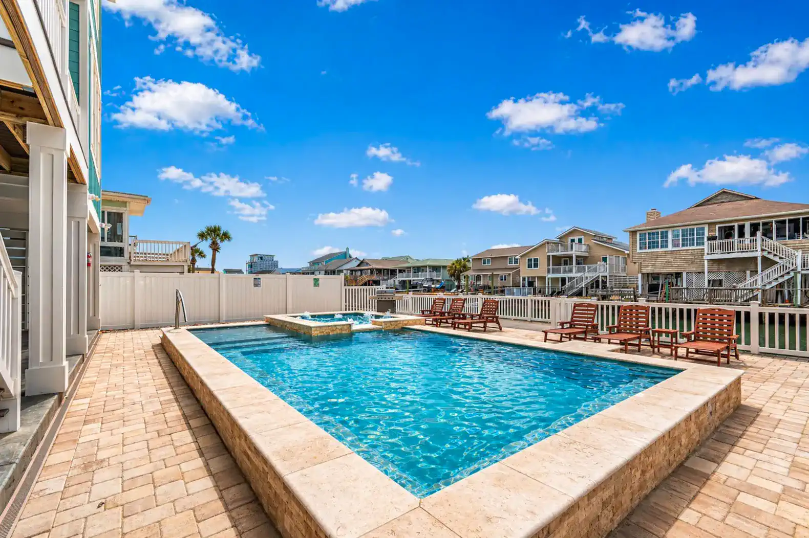 Large pool with sitting ledges on two sides.  Perfect poolside hang out.