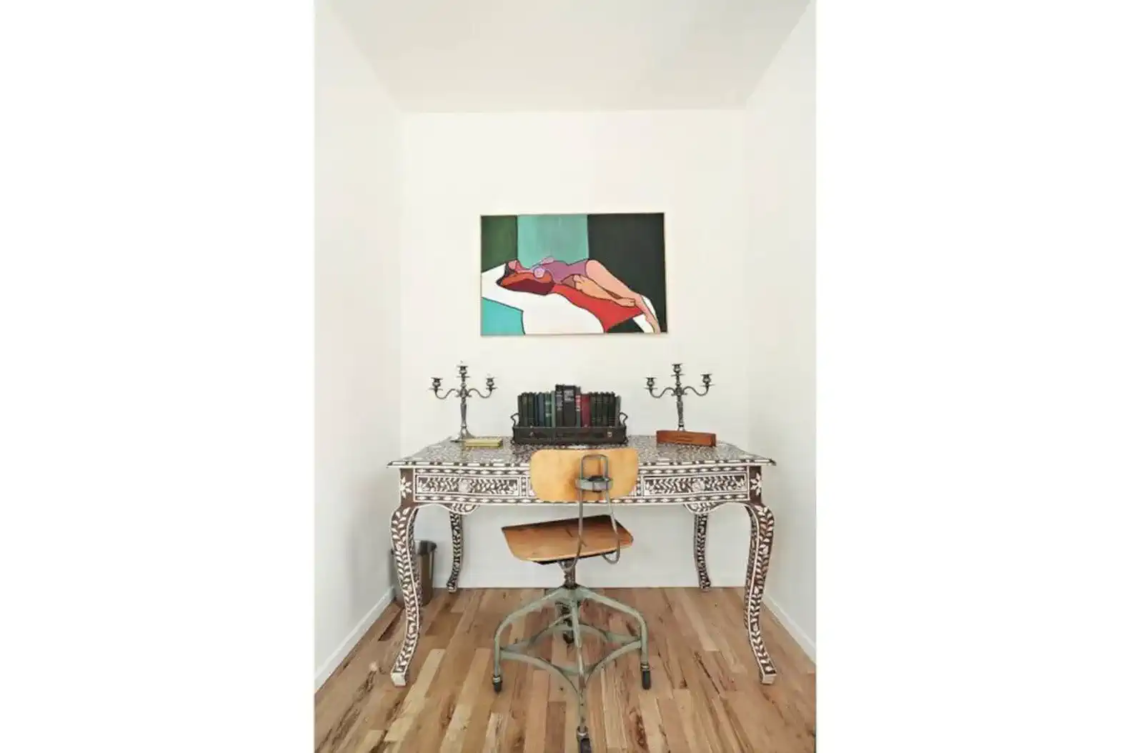 Stylish desk with artistic decor and books in a bright room