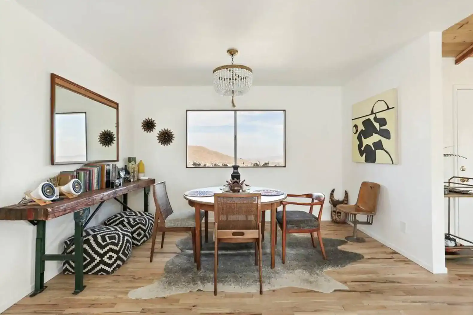 Stylish dining area with a round table, modern chairs, and decorative art pieces
