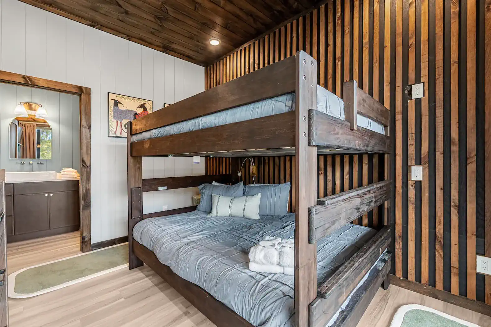 Queen bunk bed in the lowest level located off the game room with a full ensuite bathroom