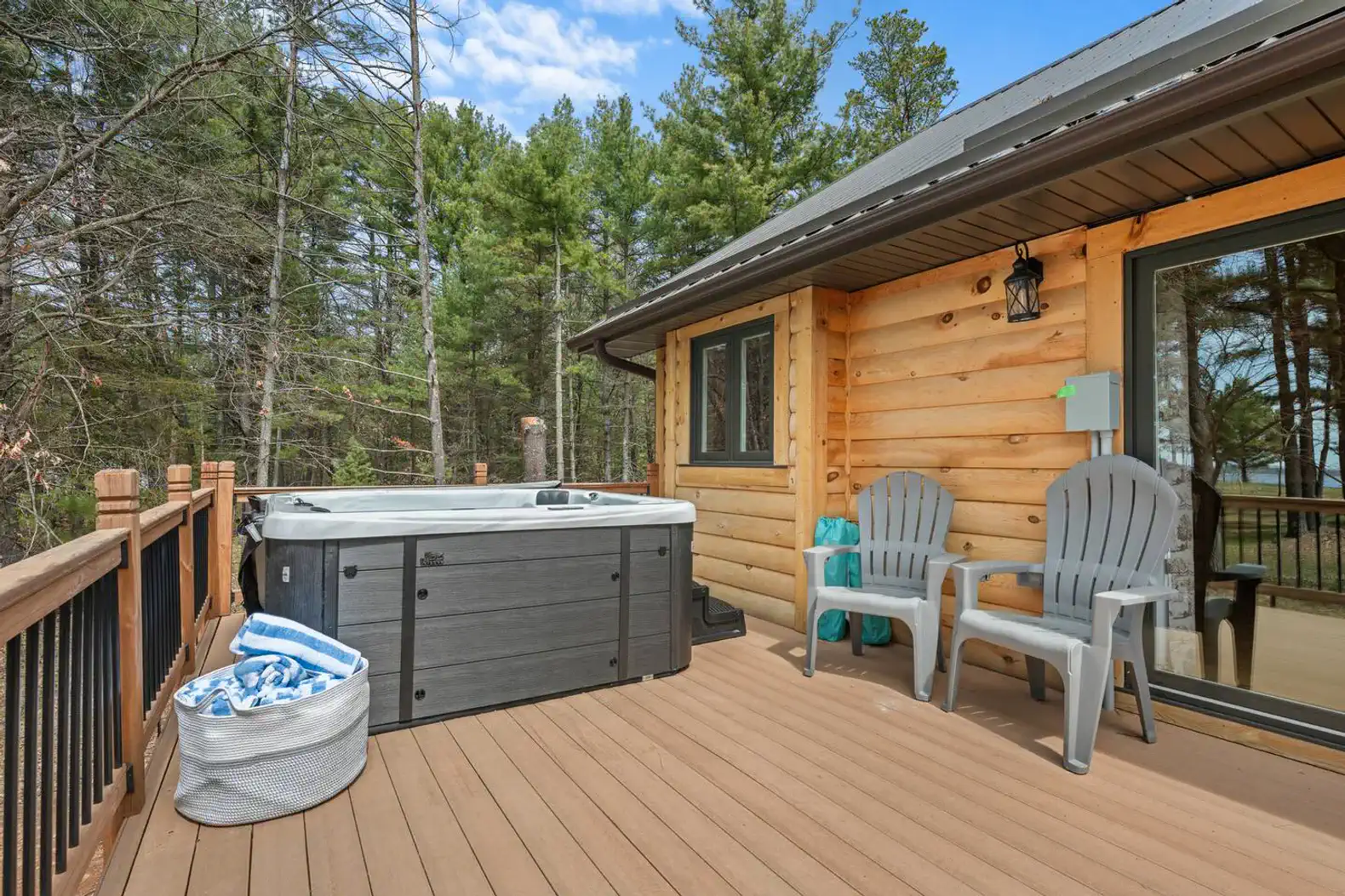 Relaxing hot tub area surrounded by trees and outdoor seating