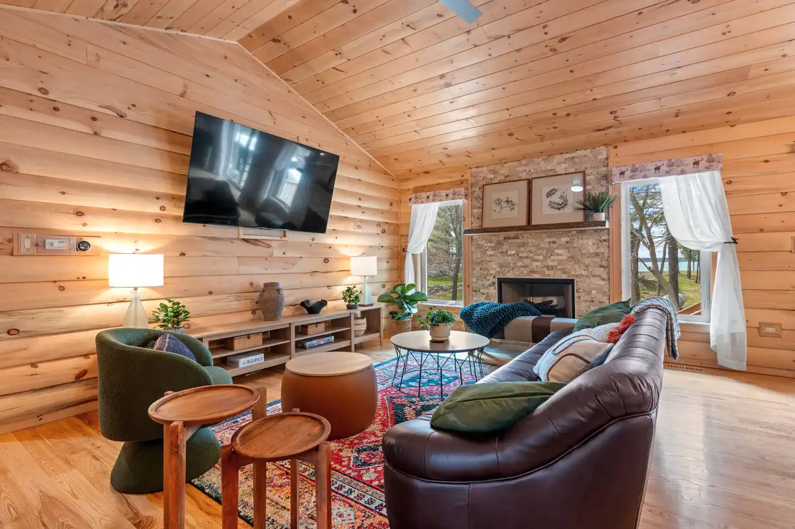 Cozy living room with wooden walls, large TV, and comfortable seating