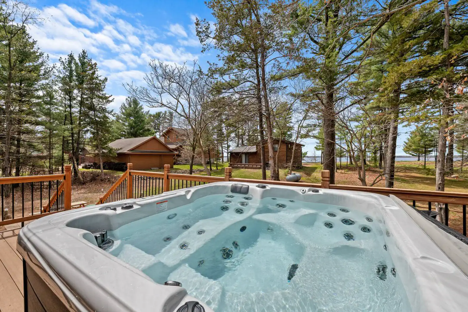 Relaxing hot tub with forest views and nearby cabins