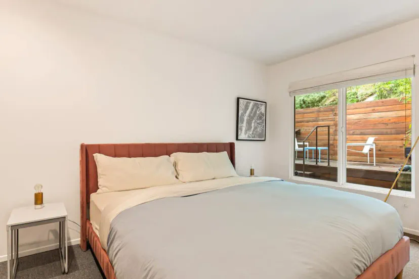 Spacious master bedroom with a large bed and access to a private outdoor deck