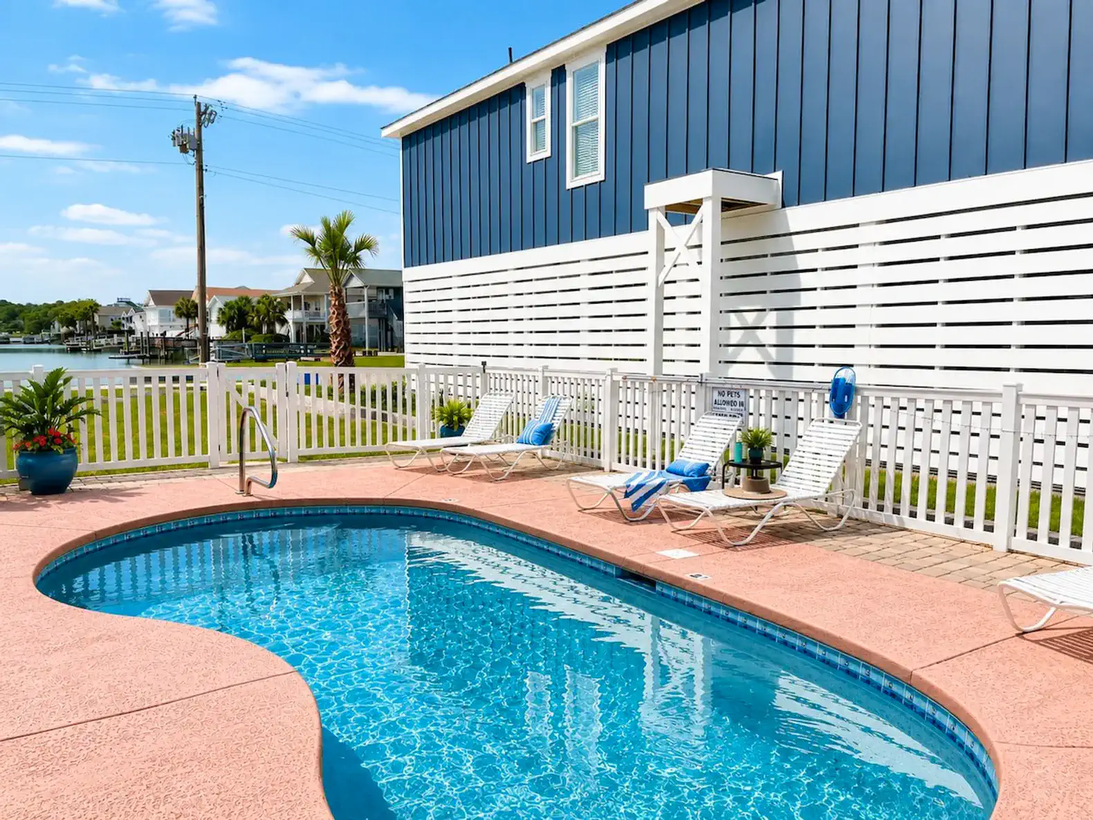 Inviting pool area with lounge chairs and a view of the surrounding landscape