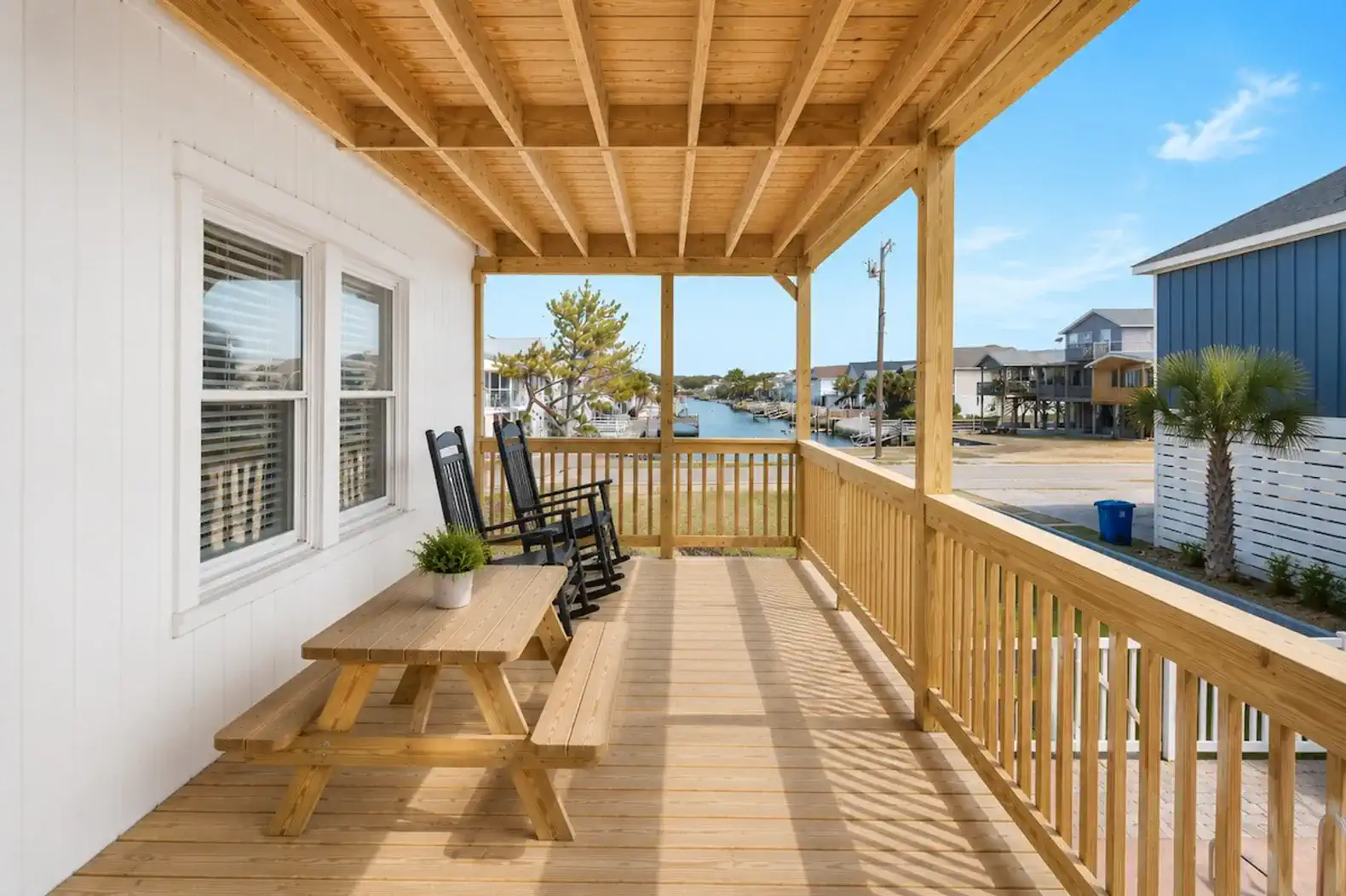 Covered porch with seating and a view of the canal