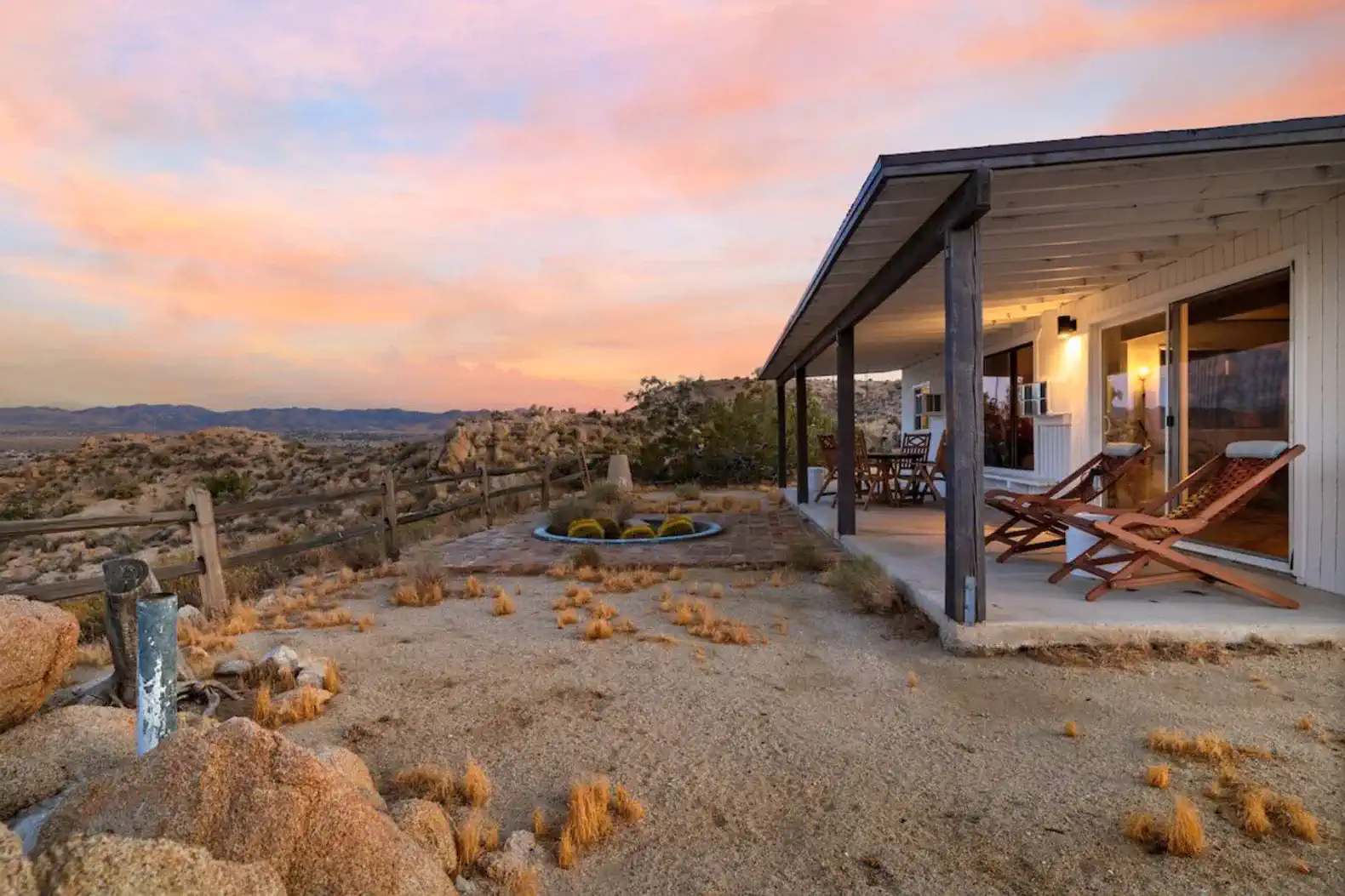 Scenic outdoor area with seating and desert landscape at sunset