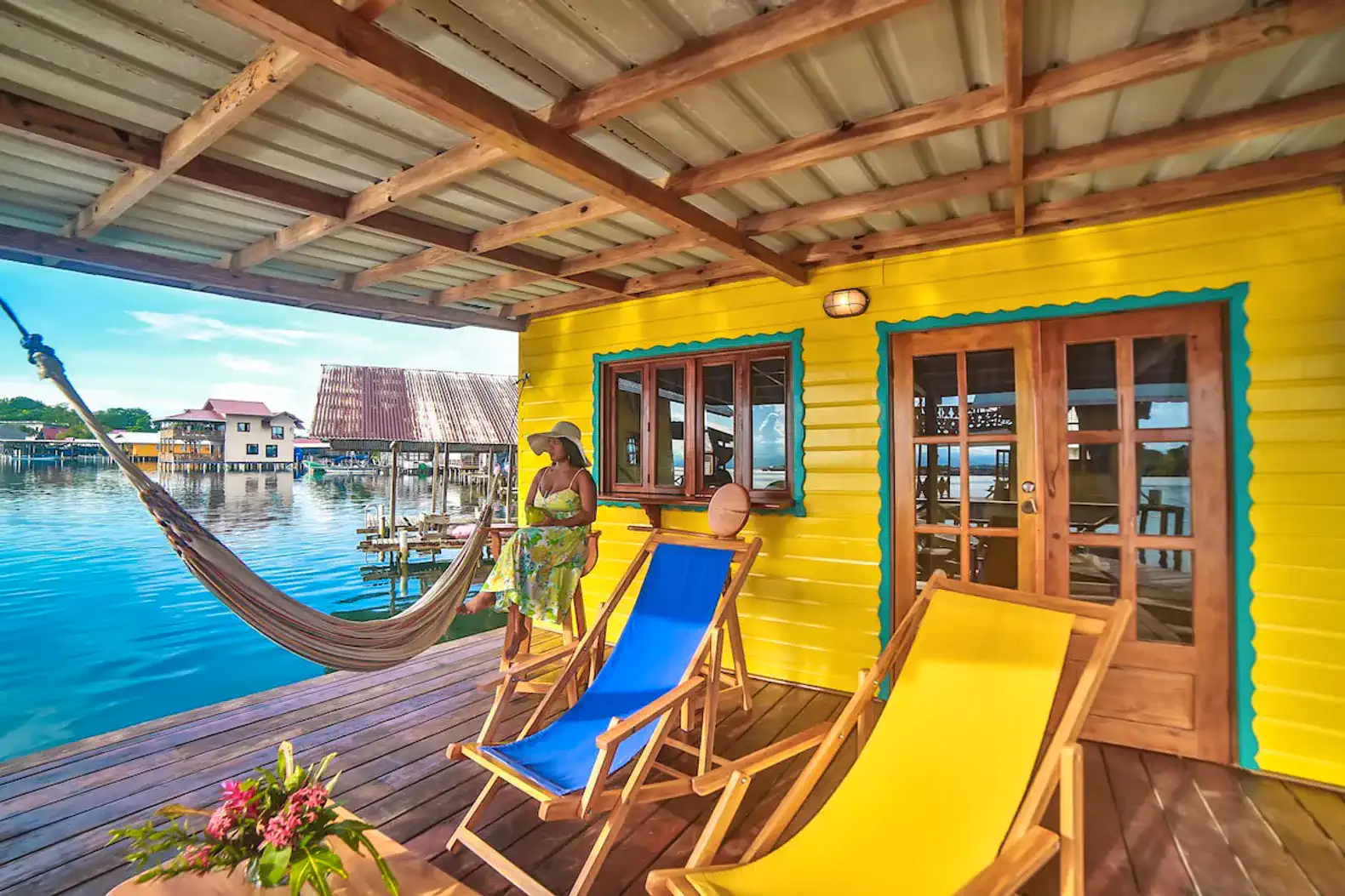Colorful outdoor seating area with a hammock and sea view