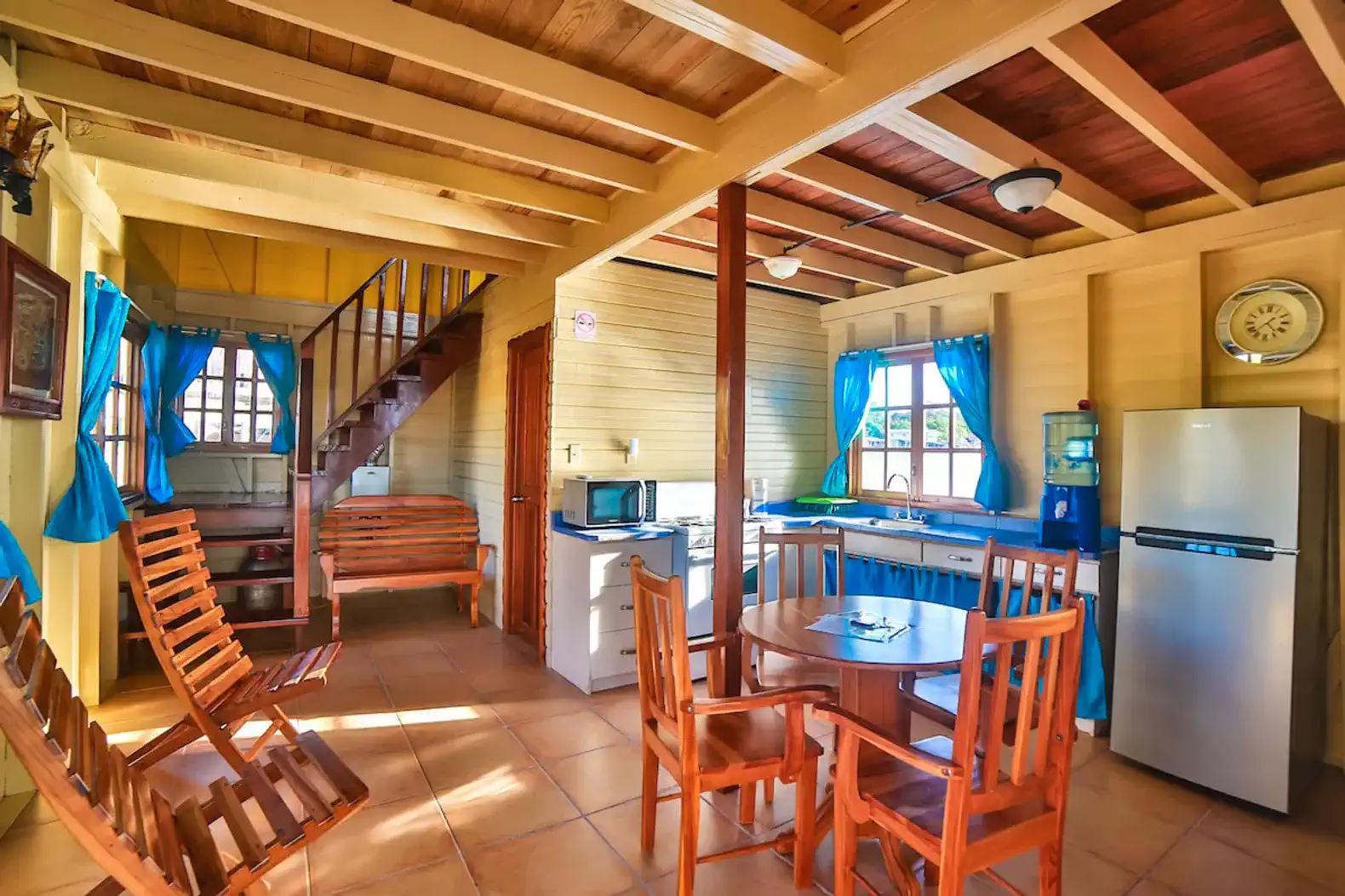 Cozy interior with dining area, kitchen, and wooden furniture