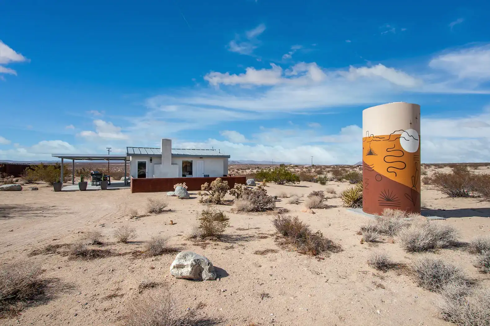 front of the house + water tower and mural by desert artist, Prescott McCarthy