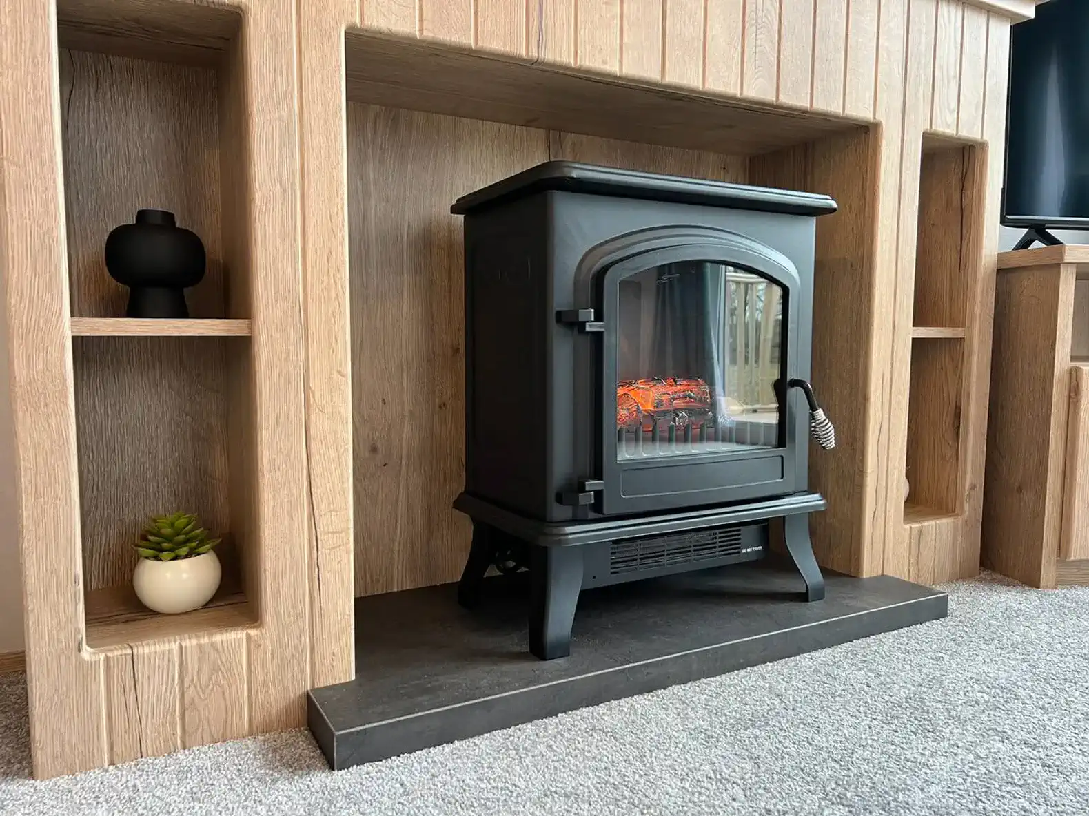 Cozy fireplace with a modern design and decorative shelves