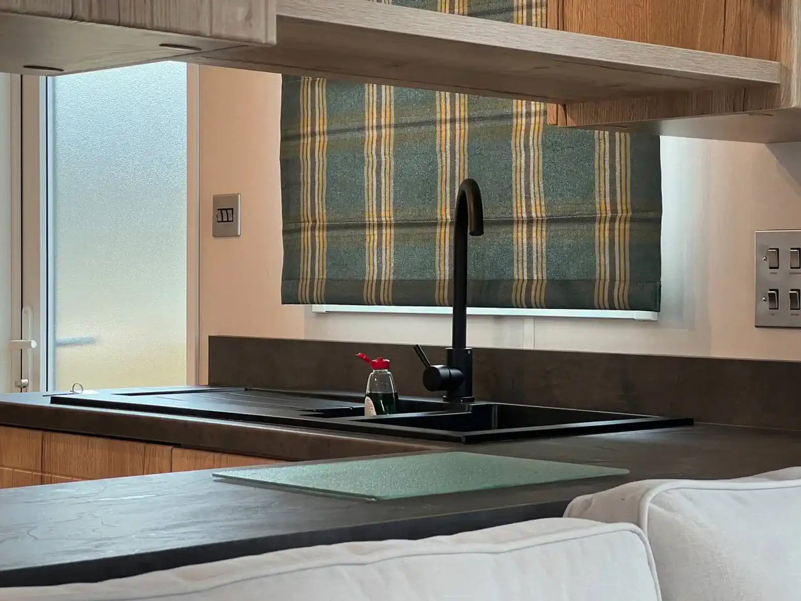 Modern kitchen with sleek black sink and wooden cabinetry