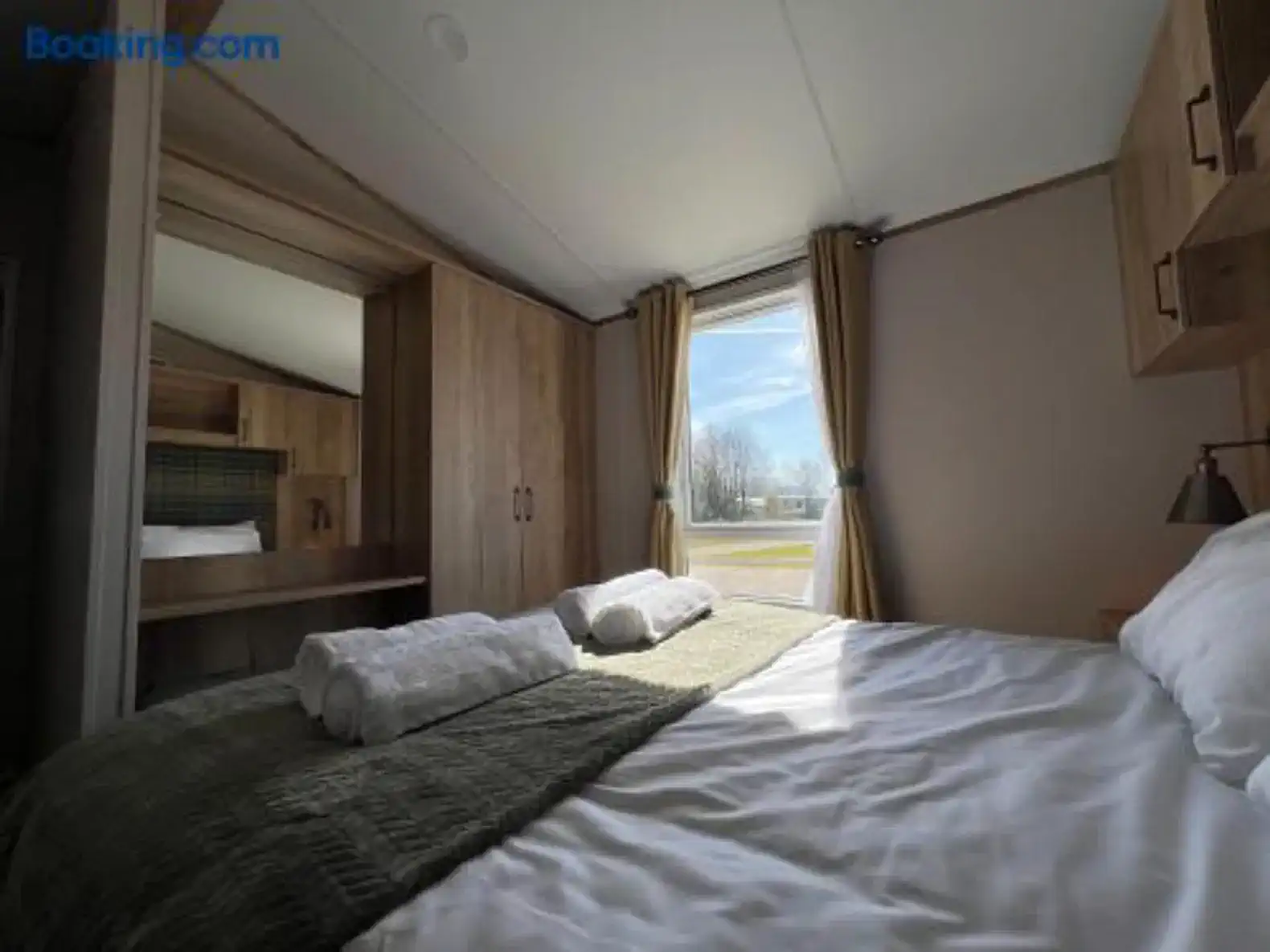 Cozy master bedroom with large window and natural light