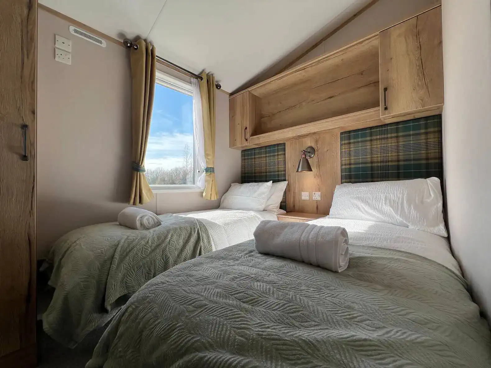 Cozy guest bedroom with two twin beds and natural light