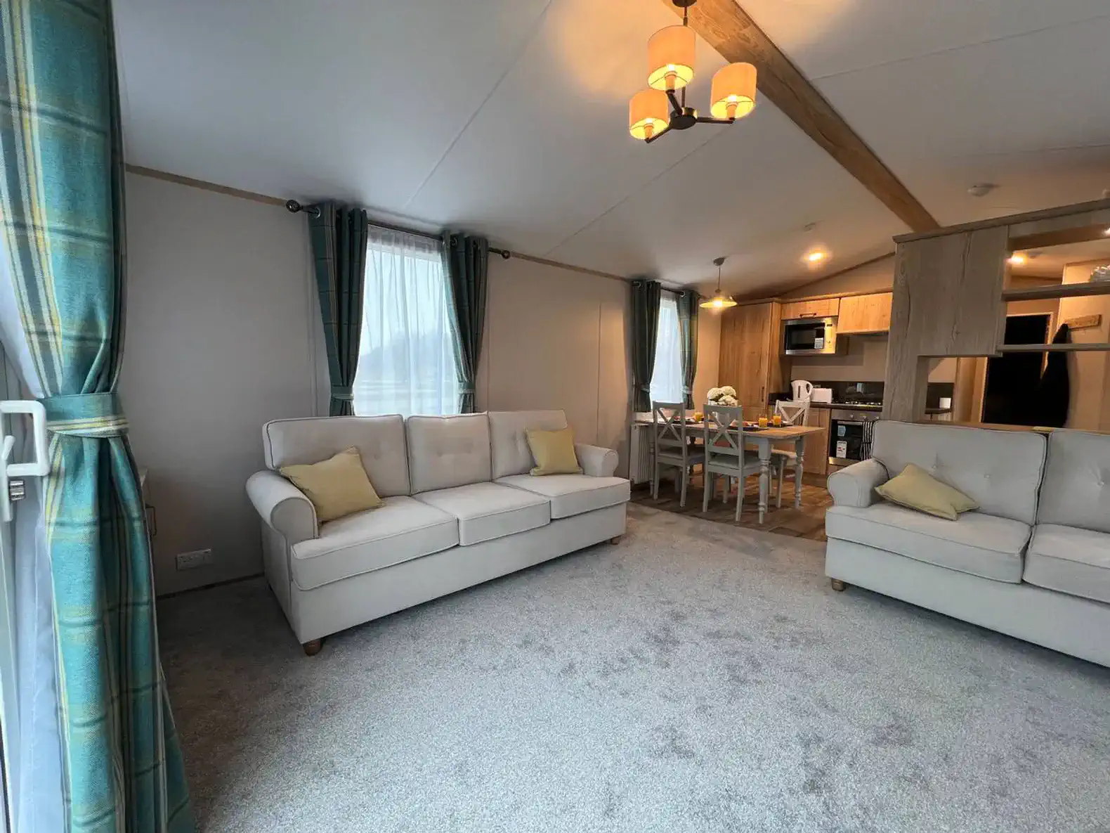 Cozy living room with two sofas, dining area, and open kitchen