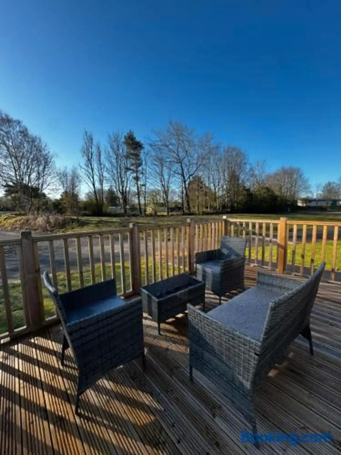 Cozy outdoor seating area with wicker furniture and a clear blue sky