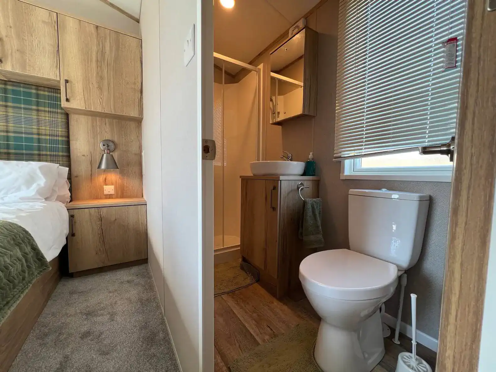 Cozy bathroom with modern fixtures and a shower, adjacent to the bedroom