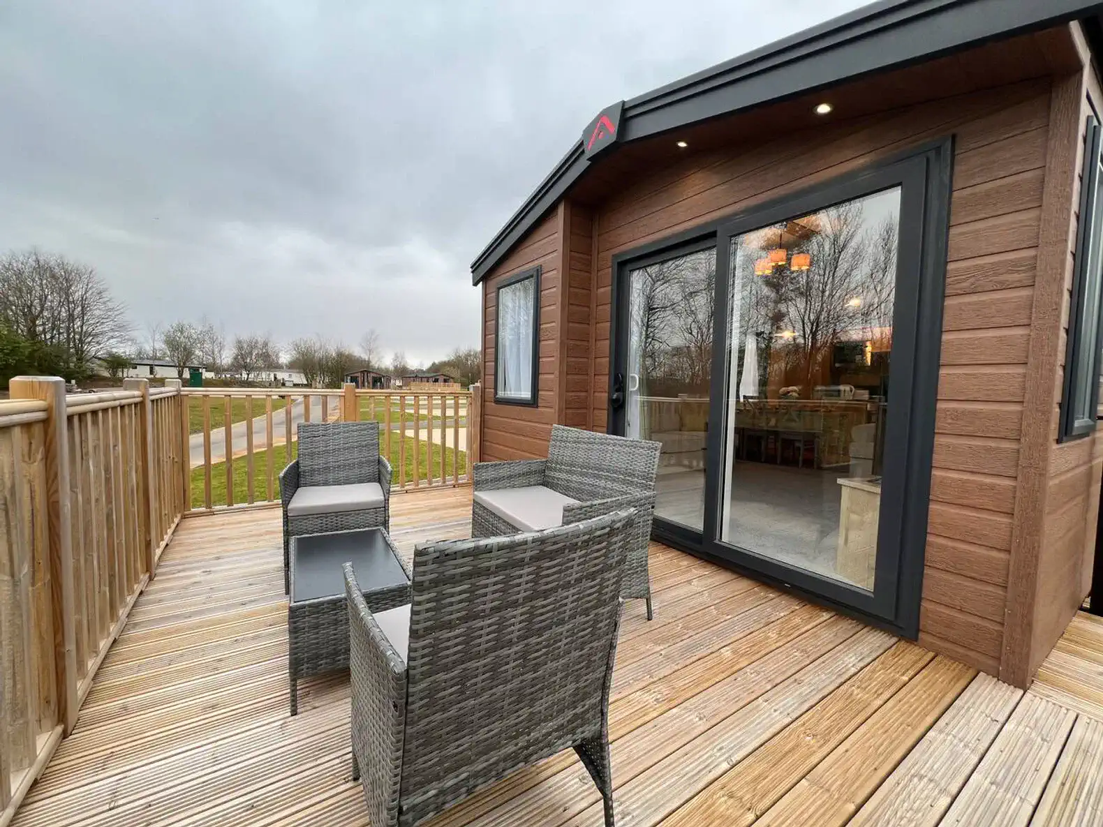 Cozy outdoor seating area with wicker chairs on a wooden deck