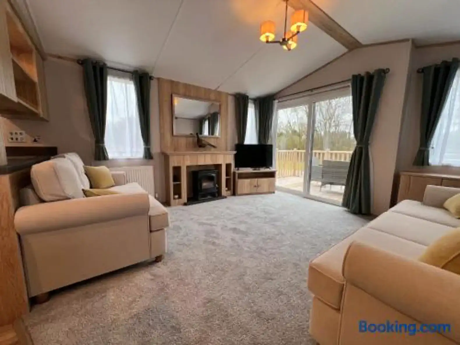 Cozy living room with large windows and access to outdoor deck