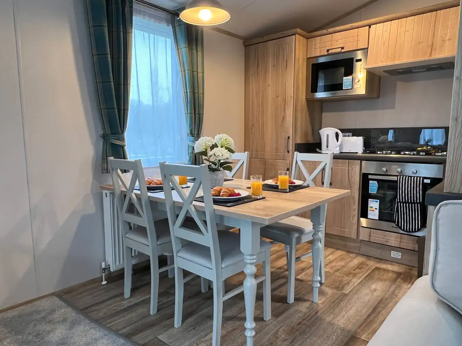 Cozy dining area with a table set for breakfast and modern kitchen appliances