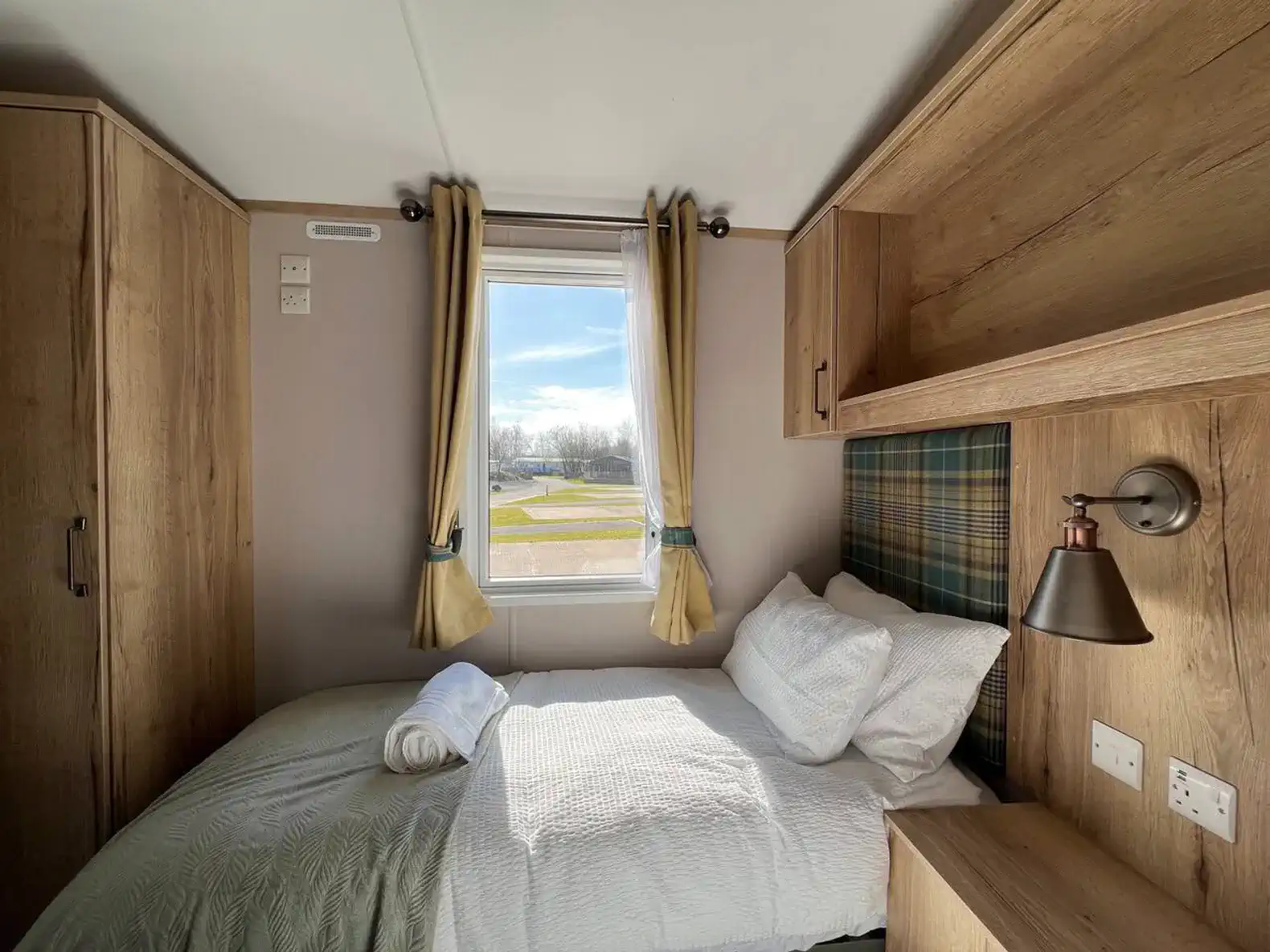 Cozy guest bedroom with a single bed and window view