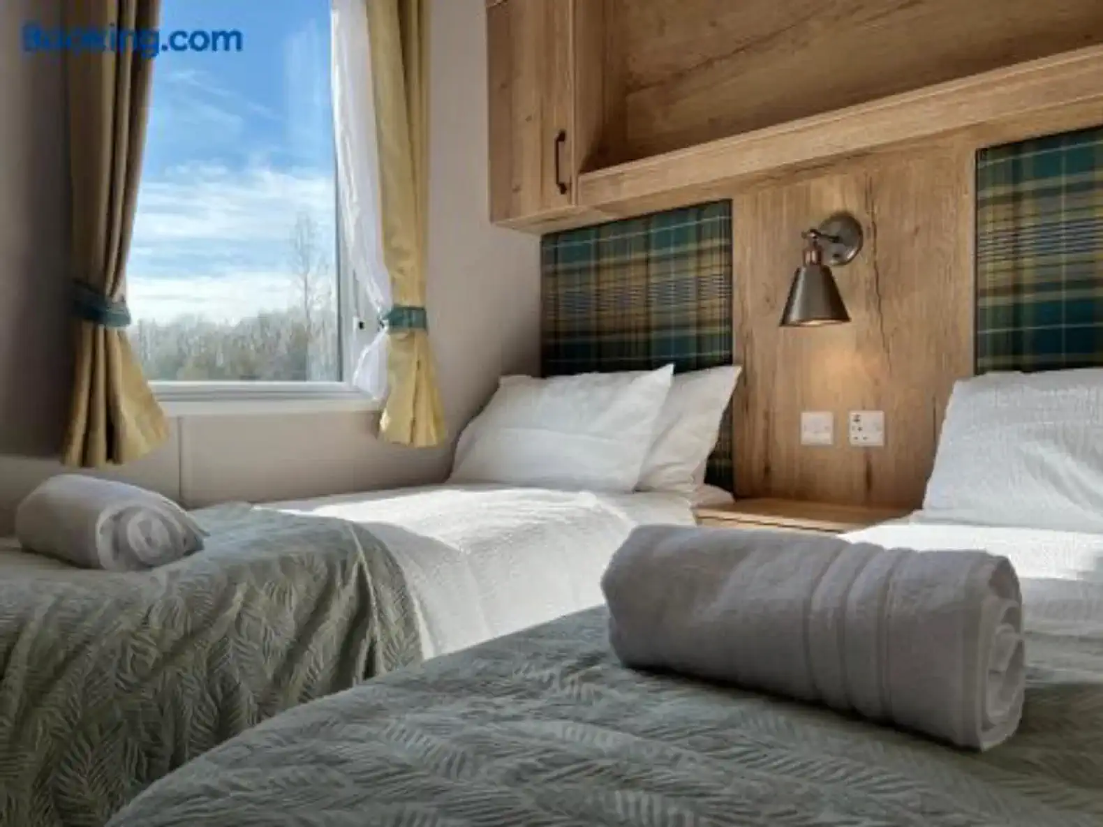 Cozy guest bedroom with two twin beds and natural light from a window