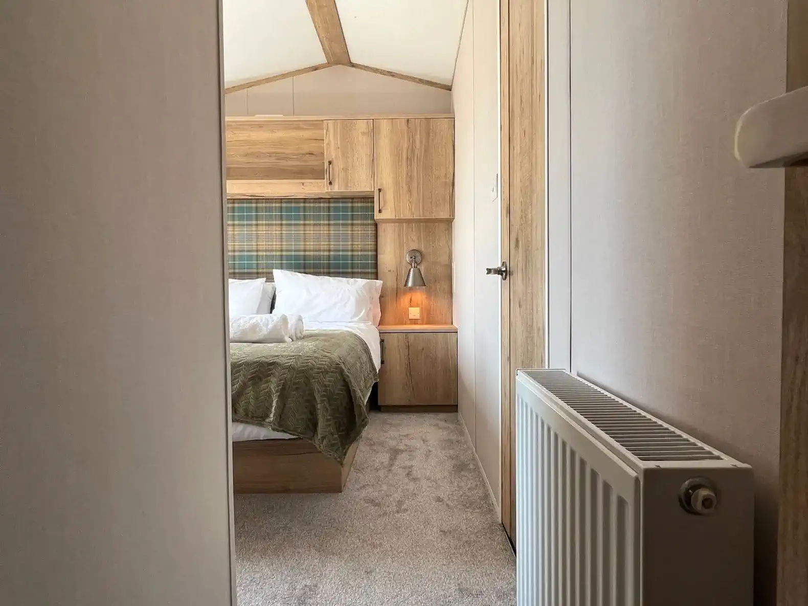 Cozy master bedroom with warm lighting and wooden accents